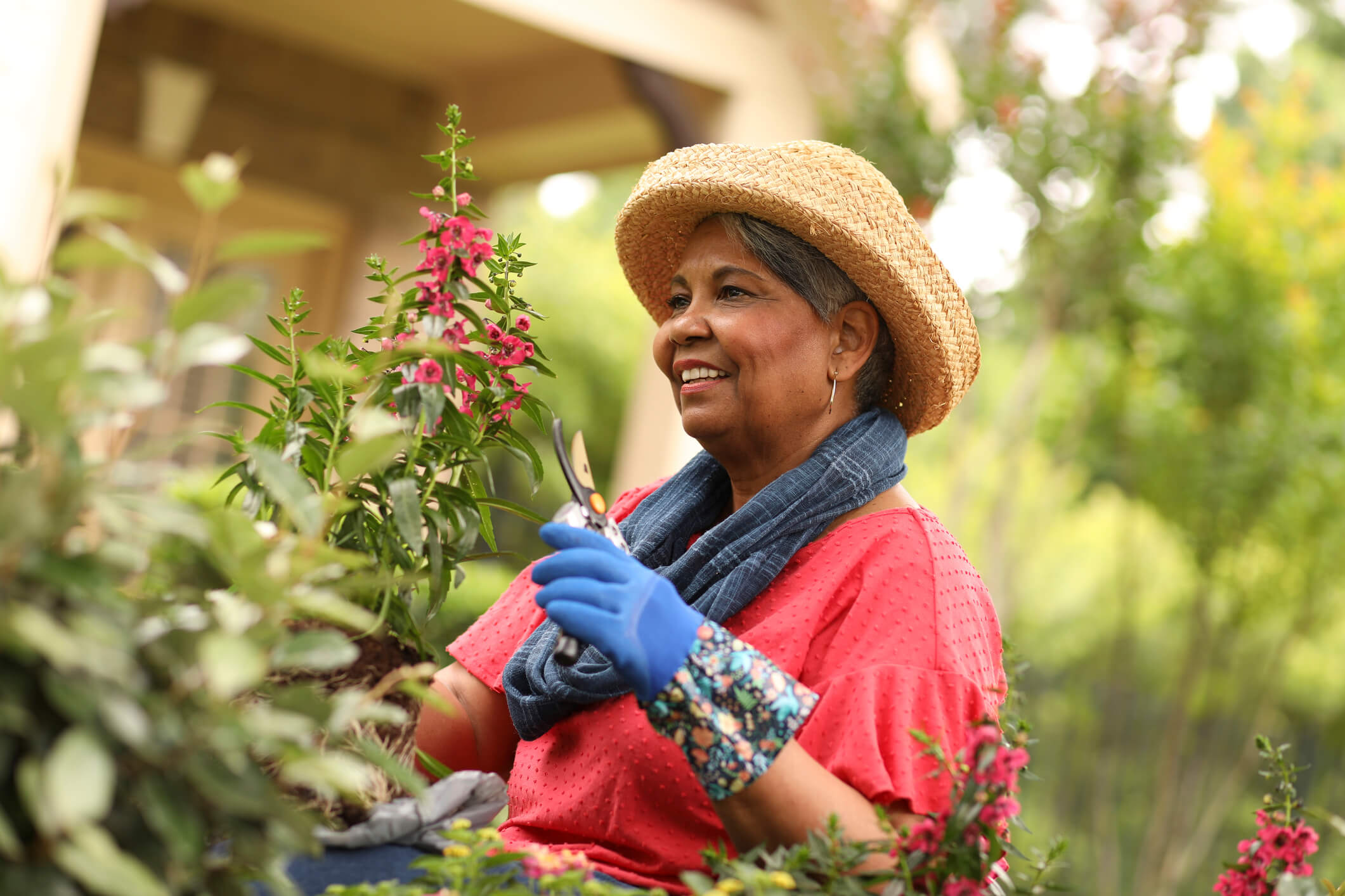 Older woman gardening on a bright summer day