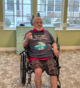 Patient John sitting in a wheelchair after his polar bear plunge