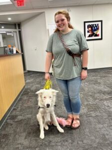 Volunteer Alexis and therapy dog Biscuit